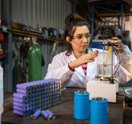 Engineer testing lithium-ion battery cells in laboratory