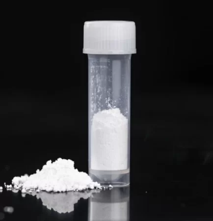 White barium sulfate powder in a transparent vial with a small pile