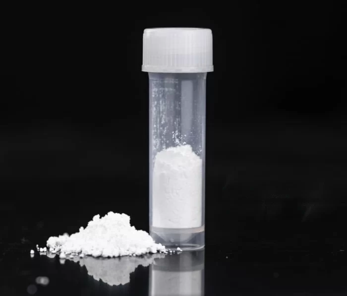 White barium sulfate powder in a transparent vial with a small pile