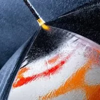 Water spraying on a coated surface with surface active agents.